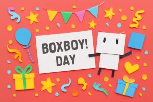 「ハコボーイ！の日」記念日を祝うカラフルな紙細工のアート。ゲーム「ハコボーイ！」の魅力を表現した楽しいデザイン。