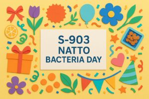 S-903納豆菌の日を記念するカラフルなペーパーアートと健康を象徴するアイテム